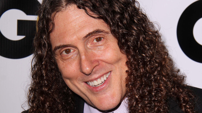 "Weird Al" Yankovic is smiling at an event.