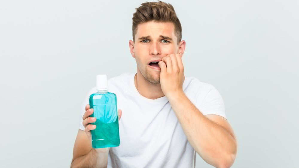 Nervous man with mouthwash