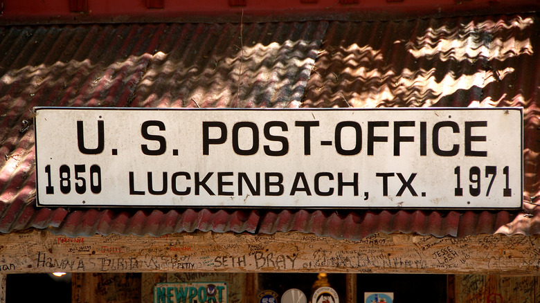 Post office sign in Luckenbach, Texas on metal roof