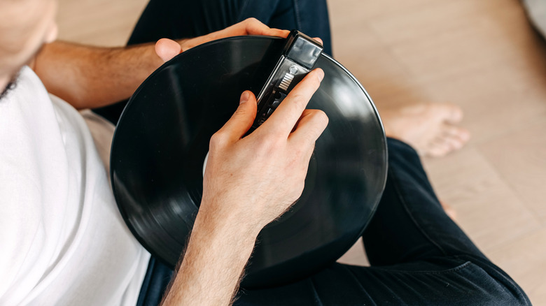 Man cleaning a vinyl record