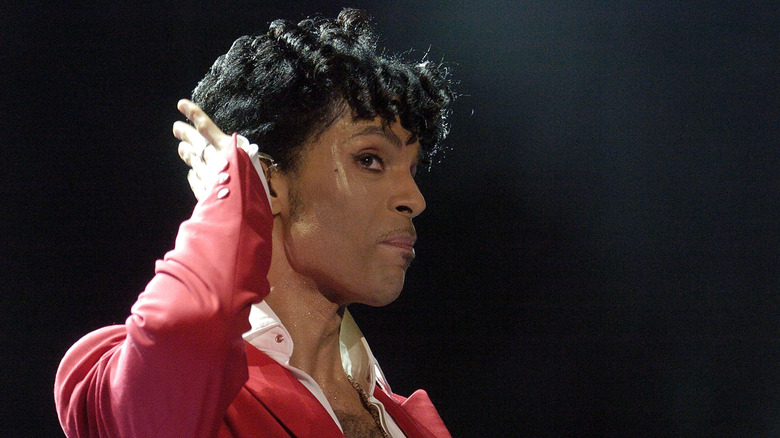 Prince on stage with hand to ear