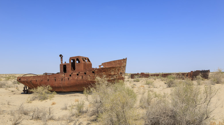 rusting ships on the dry bed of the aral sea