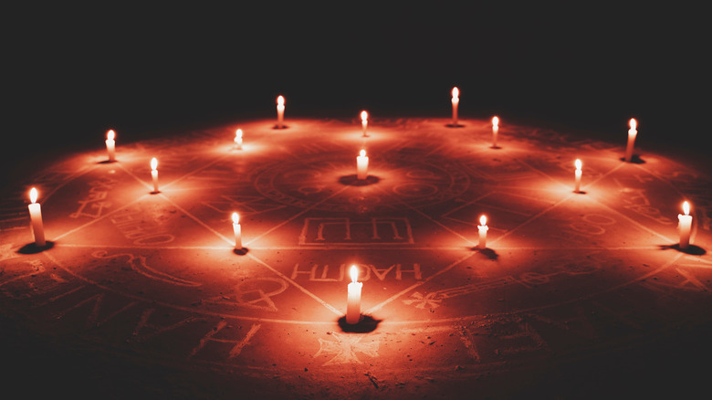 Candles arranged within arcane symbols