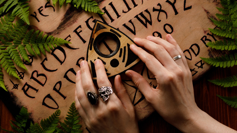 ouija board hands on planchette