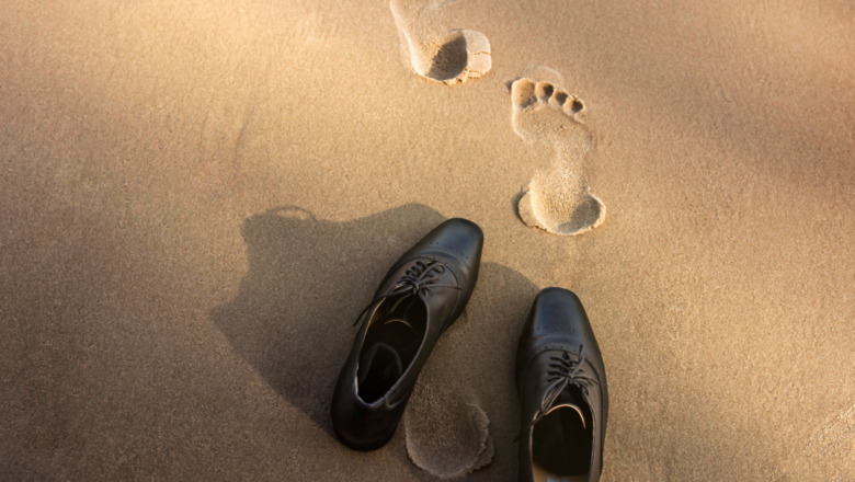 Beach with shoes and footprints