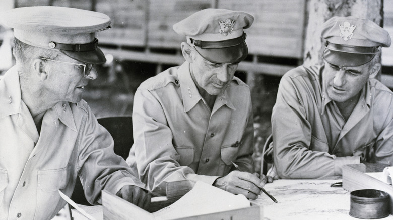 General Nathan Twining and two other officers looking at a map