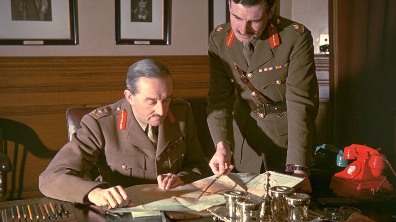 An aide to Field Marshall Alan Brooke showing him something on a map
