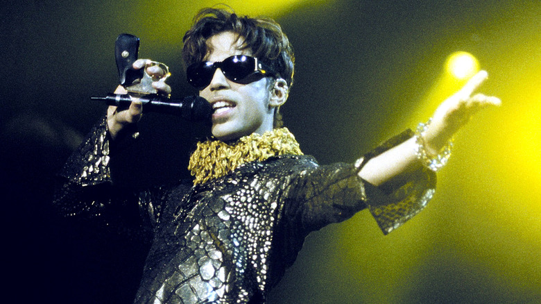 Prince wearing sunglasses while performing onstage