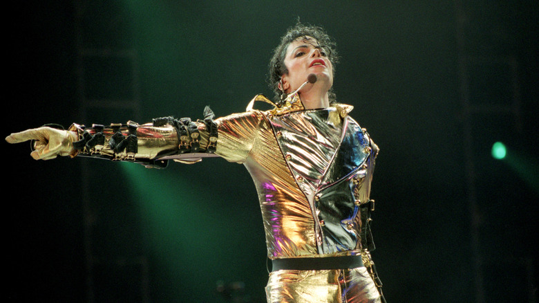 Michael Jackson in a gold jumpsuit performing onstage