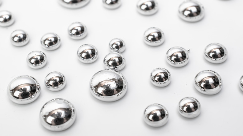 Drops of mercury on white surface