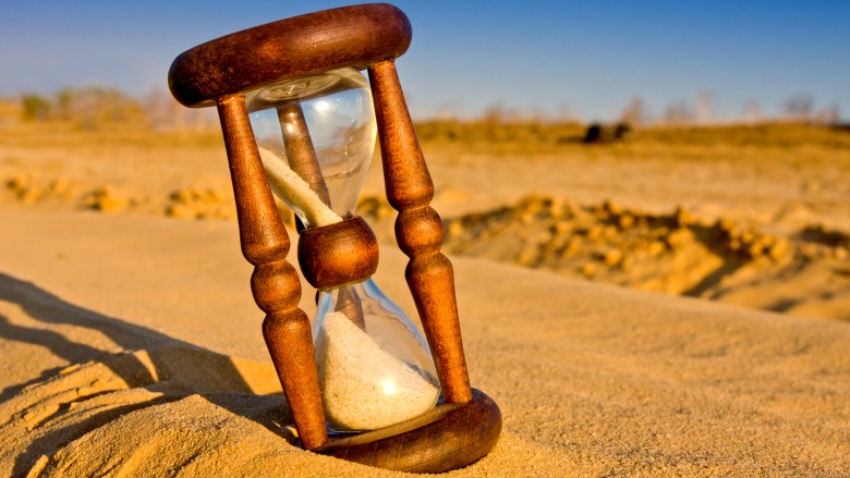 hourglass in desert field