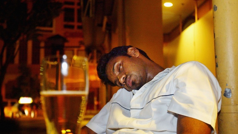 man passed out in a bar