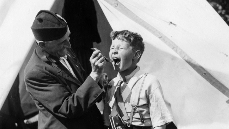 kid being fed castor oil