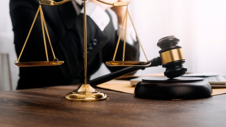 lawyer behind scales of justice