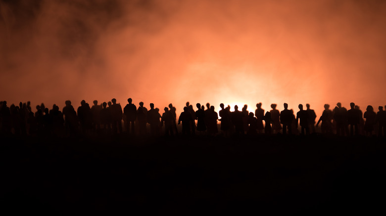 people gathering orange sky silhouette