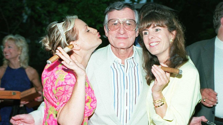 Hugh Hefner posing with guests