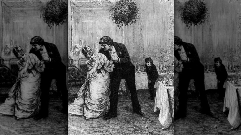 Couple flirts at kissing ball
