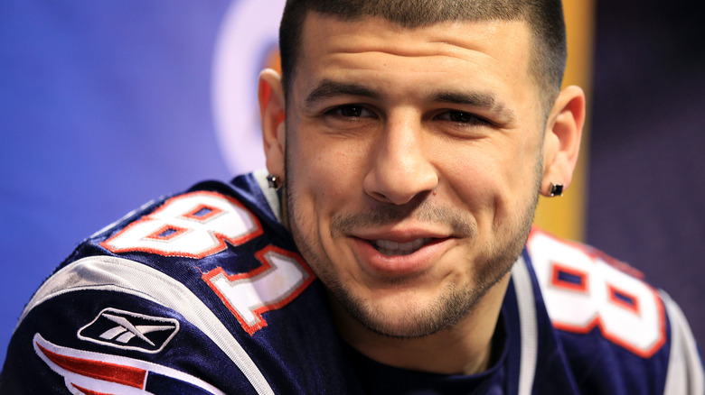 aaron hernandez wearing patriots jersey smiling