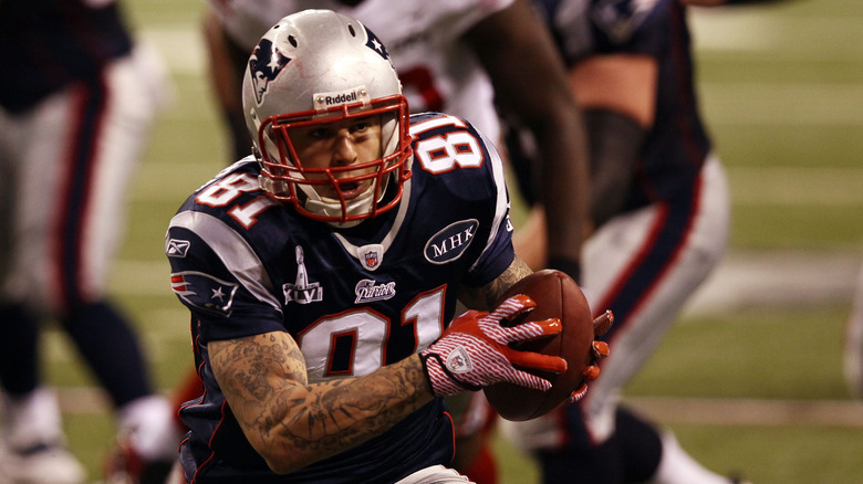 aaron hernandez patriots holding football