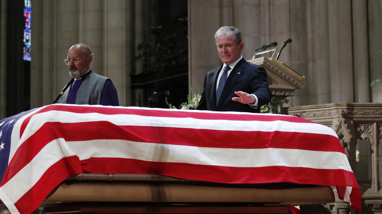 George W. Bush touching coffin at funeral