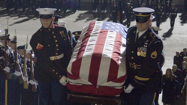 Soldiers carrying flag draped coffin
