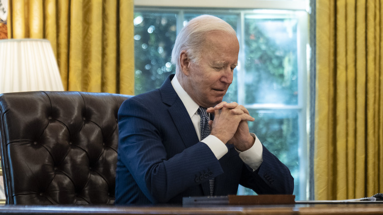 Joe Biden sitting thoughtfully Oval office