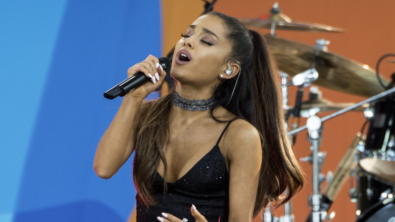 Ariana Grande performing with a sparkly earpiece
