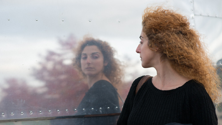 woman looking on window