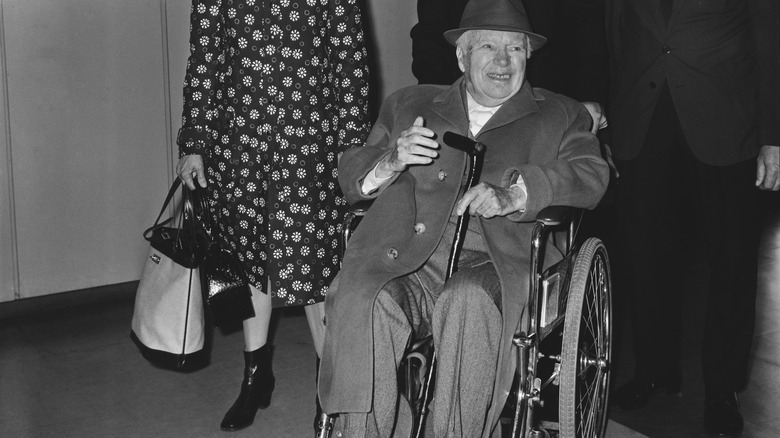 Charlie Chaplin in wheelchair smiling hat