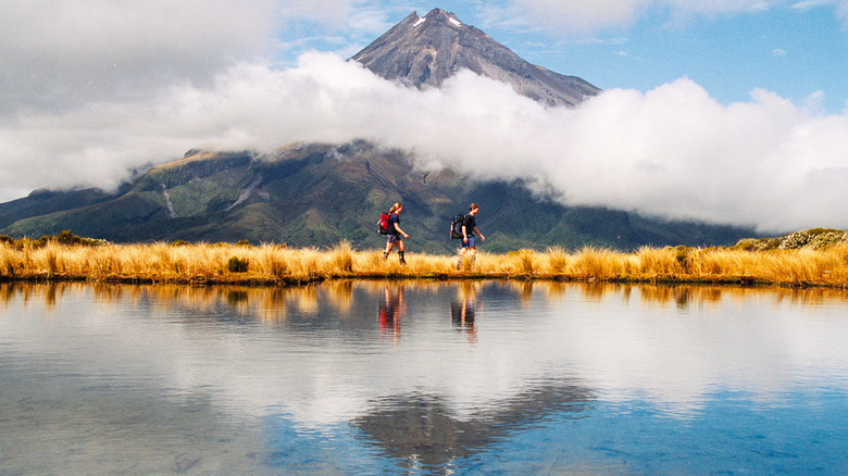 people hiking in front of a volcano in New Zealand
