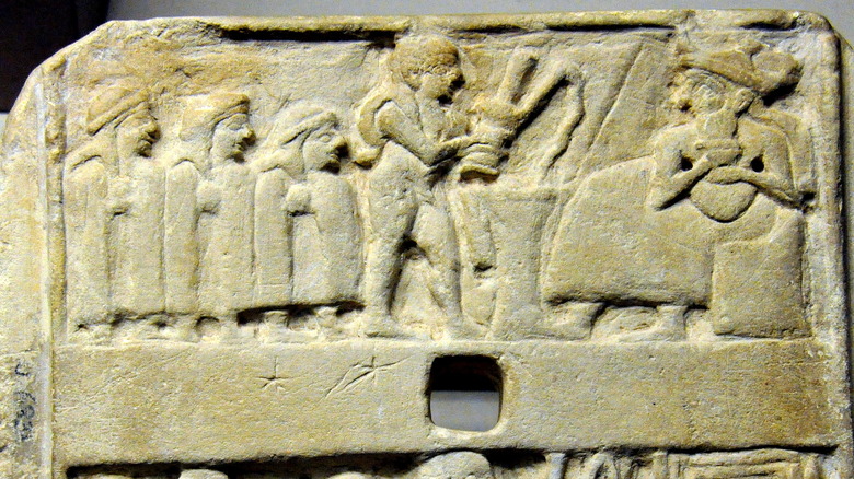 Wall plaque showing libation scene from Ur, Iraq, 2500 BCE