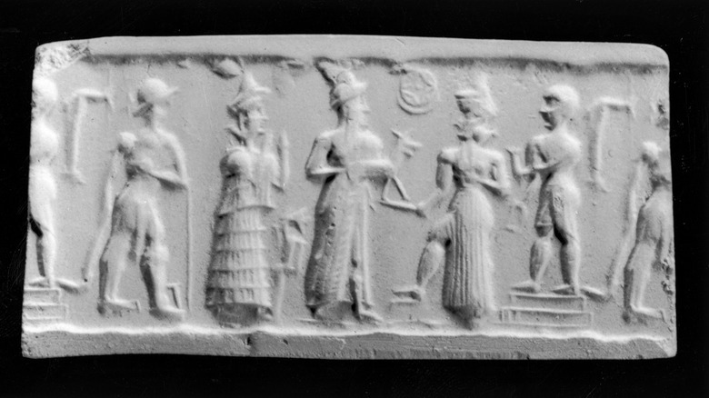 Mesopotamian cylinder seal with deity accepting an offering