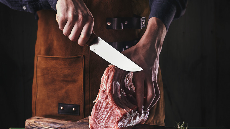 Knife cutting meat