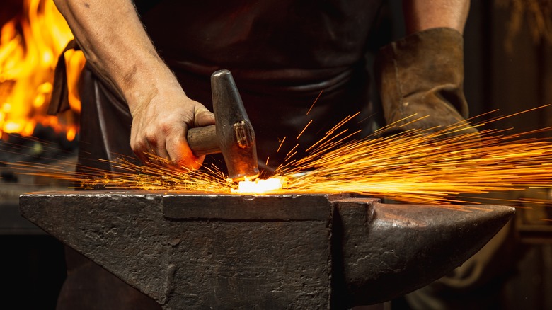 Blacksmith forging on an anvil
