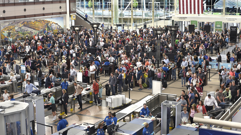 passengers lined up to go through a TSA checkpoint
