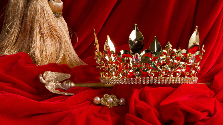 crown and scepter on red velvet