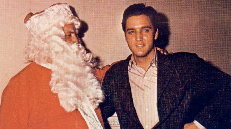 Elvis Presley with Colonel Tom Parker as Santa Claus