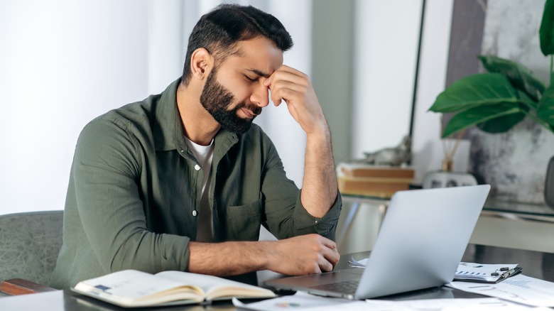 man at computer feeling failure