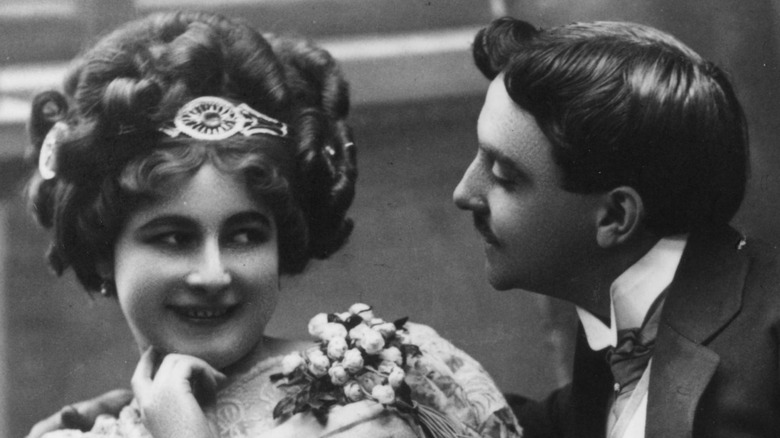 a victorian era couple flirting with each other