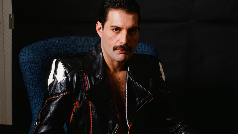 freddie mercury sitting for a studio portrait