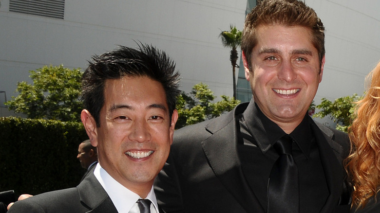 Grant Imahara and Tory Belleici smiling on red carpet