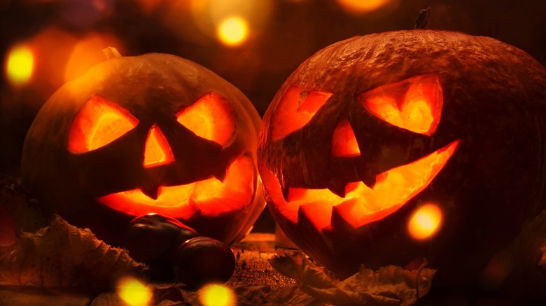 Two jack-o'-lanterns glowing in the dark