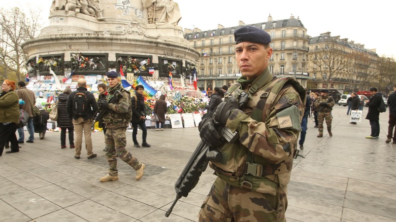troops in Paris 2015 in front of memorial tributes