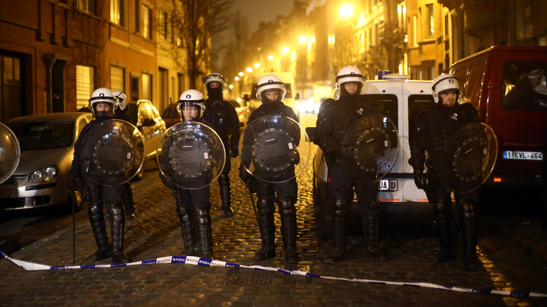 police officers in riot gear patrol Molenbeek Belgium
