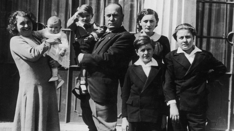 Benito, Rachele Mussolini and children standing outside