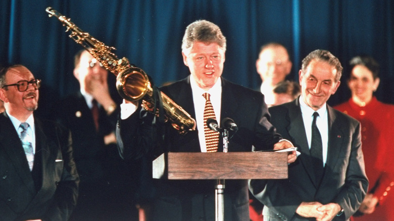 Bill Clinton receiving saxophone gift from NATO