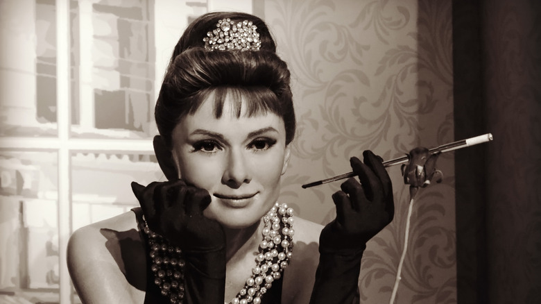 audrey hepburn holding a cigarette holder