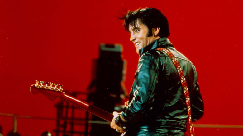 Elvis Presley on stage in black leather