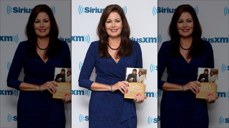 Ginger Alden posing with book