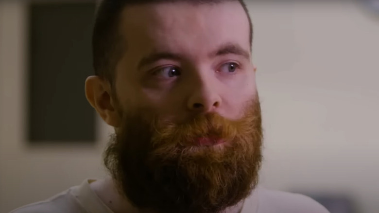 Nicholas Godejohn looks left